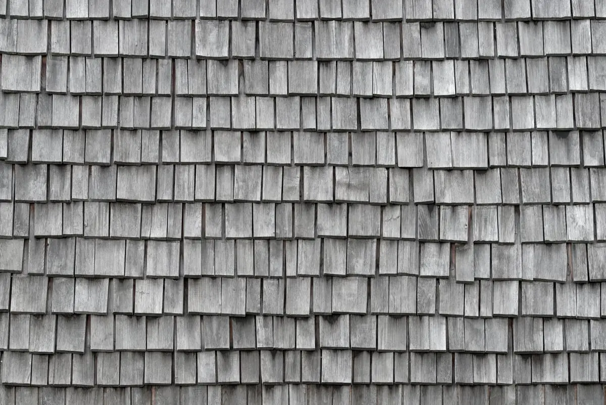Close-up of weathered cedar shake shingles on a Calgary roof