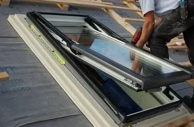 Skylight unit being fitted and flashed into a roof deck
